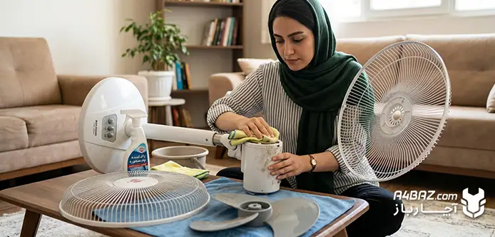 یک زن در حال تمیز کردن پنکه ایستاده